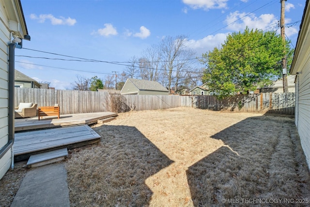 view of yard featuring a deck and a fenced backyard