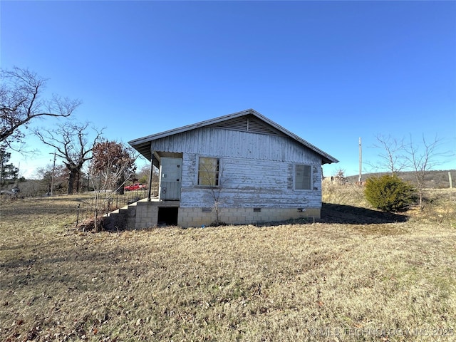 view of side of home with crawl space