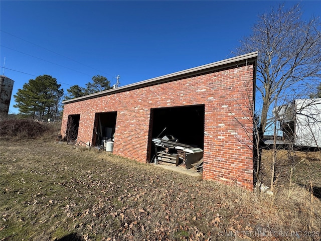 exterior space with an outbuilding and brick siding