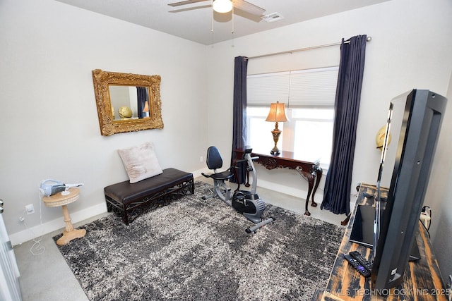 exercise room featuring visible vents, a ceiling fan, and baseboards