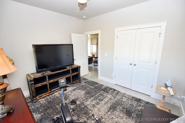 interior space featuring a closet, baseboards, and ceiling fan