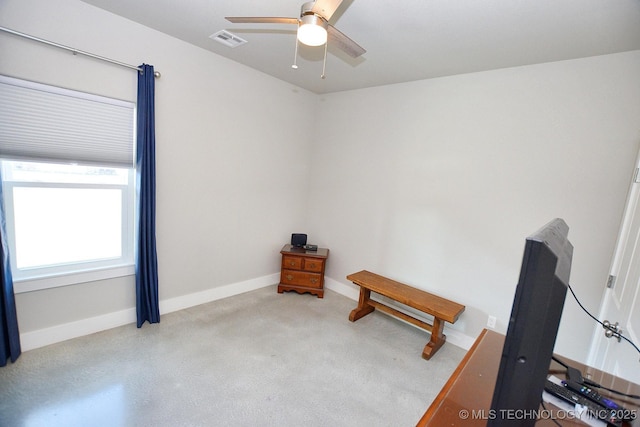 interior space with a ceiling fan, baseboards, and visible vents