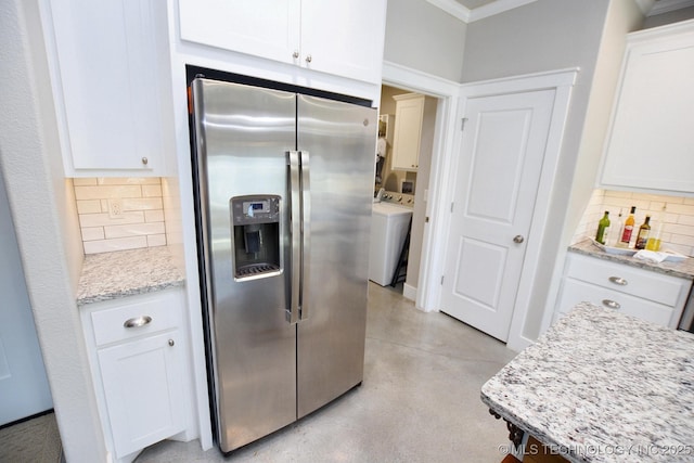 kitchen with stainless steel fridge, backsplash, washer / clothes dryer, and white cabinetry