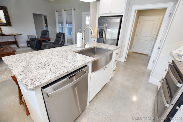 kitchen with white cabinetry, a kitchen island with sink, appliances with stainless steel finishes, and a sink