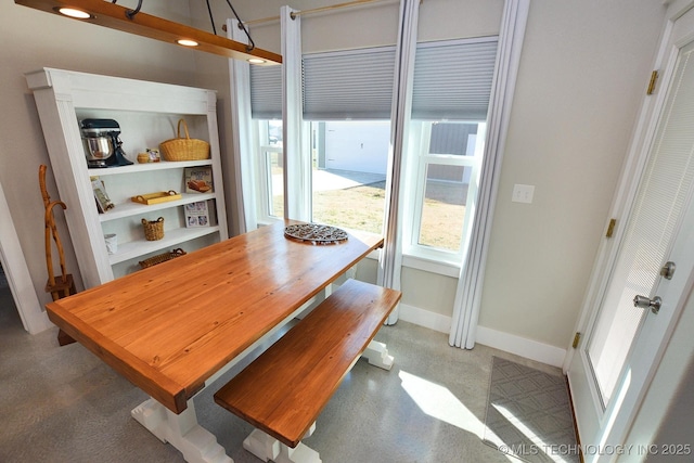 dining area featuring baseboards