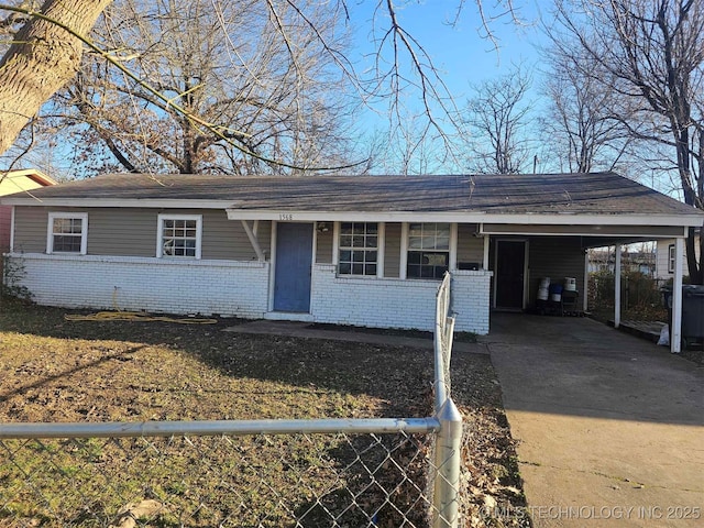 single story home with a carport, concrete driveway, and brick siding