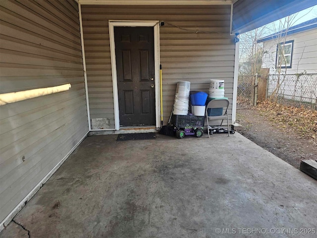 view of exterior entry featuring fence