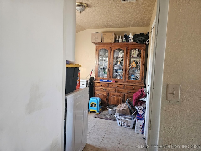 view of exterior entry featuring visible vents and independent washer and dryer