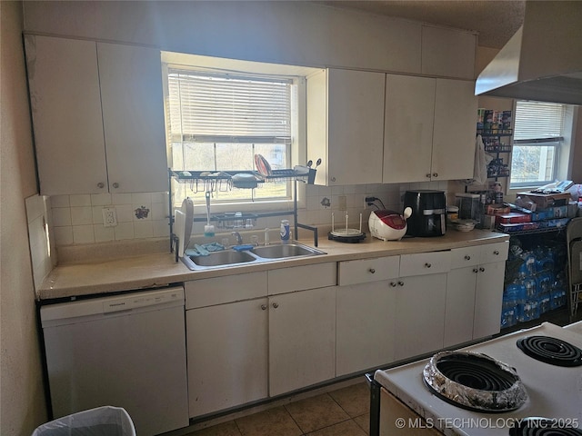 kitchen featuring tasteful backsplash, range hood, white appliances, and a sink