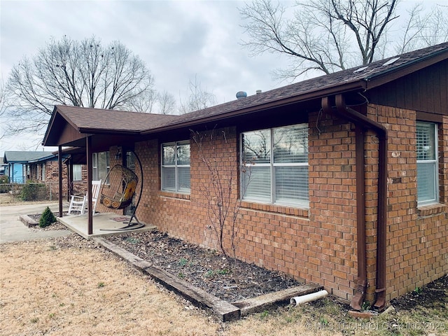 view of home's exterior with brick siding