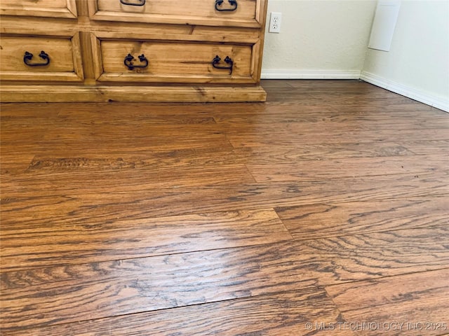 room details with baseboards and wood finished floors