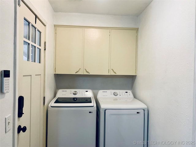 laundry room with cabinet space and washing machine and clothes dryer