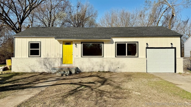 view of front of home featuring brick siding, roof with shingles, concrete driveway, and an attached garage