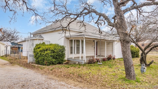 exterior space with a porch and fence