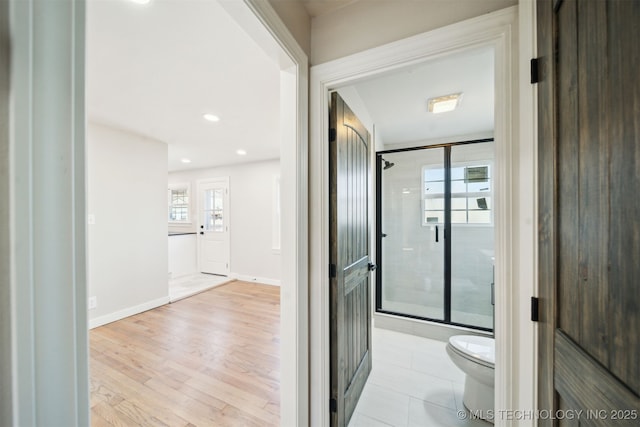 full bath featuring baseboards, toilet, recessed lighting, a stall shower, and wood finished floors