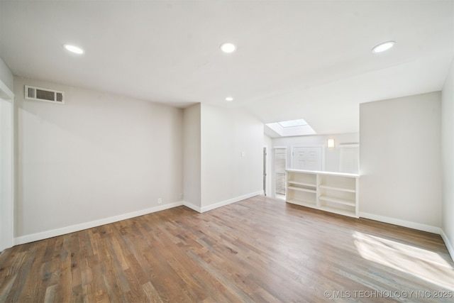 basement featuring recessed lighting, visible vents, baseboards, and wood finished floors