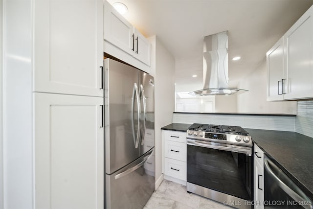 kitchen with dark countertops, appliances with stainless steel finishes, white cabinets, and island range hood