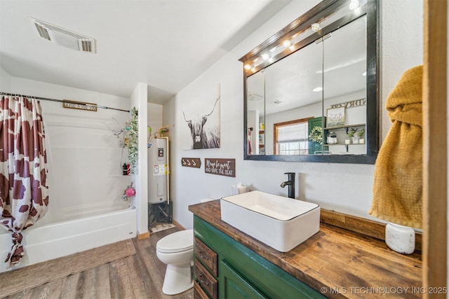 full bathroom with visible vents, toilet, water heater, shower / tub combo, and vanity