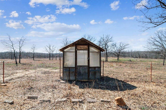 view of outdoor structure with an outbuilding and a rural view