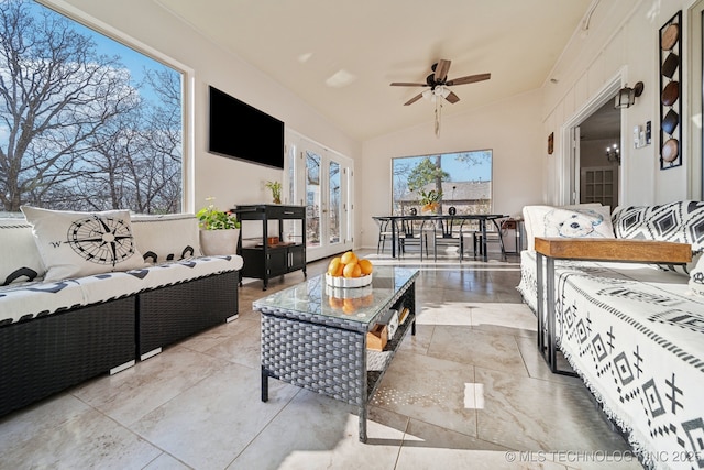 living area featuring lofted ceiling and ceiling fan