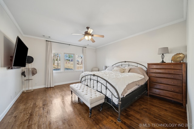 bedroom featuring visible vents, a ceiling fan, wood finished floors, crown molding, and baseboards