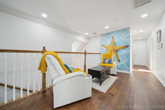 living area featuring recessed lighting, visible vents, baseboards, and wood finished floors