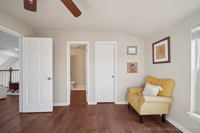 sitting room with lofted ceiling, baseboards, dark wood-type flooring, and ceiling fan