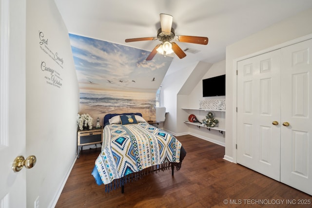 bedroom featuring visible vents, baseboards, lofted ceiling, and wood finished floors