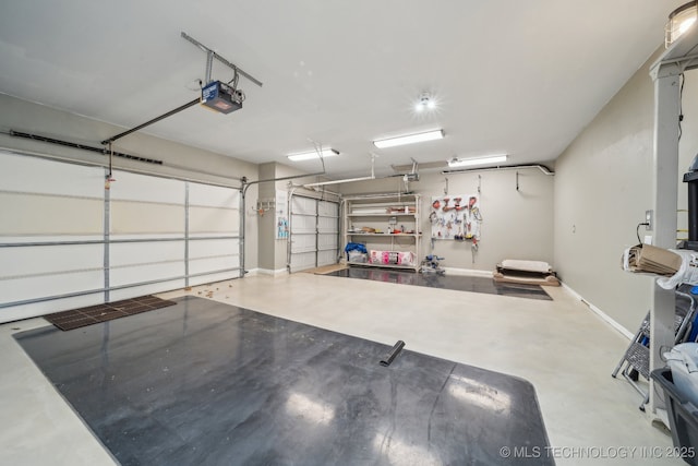 garage with a garage door opener and baseboards