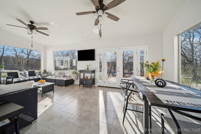 sunroom with a healthy amount of sunlight, french doors, and ceiling fan