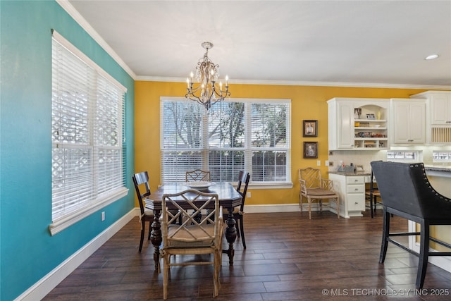 dining space featuring dark wood finished floors, crown molding, baseboards, and a chandelier