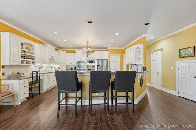 kitchen featuring open shelves, a kitchen breakfast bar, and appliances with stainless steel finishes