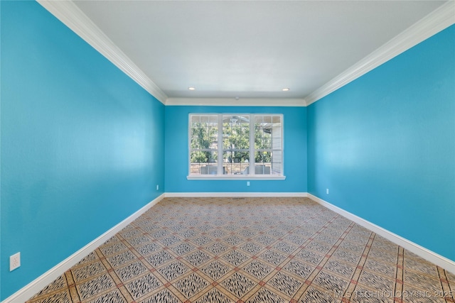 empty room featuring baseboards and ornamental molding