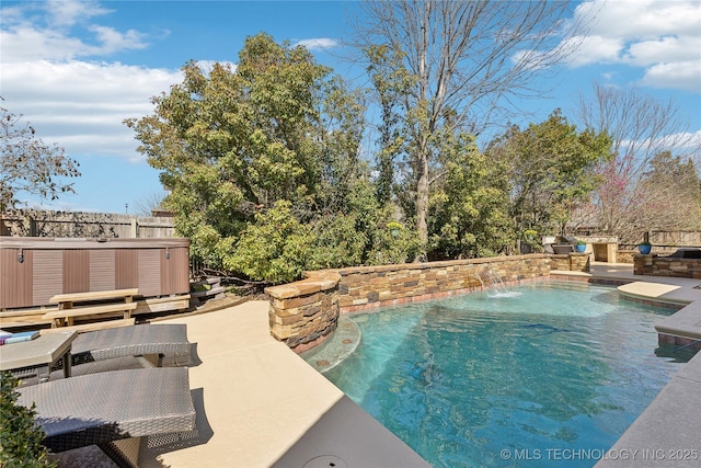 outdoor pool featuring a patio area, fence, and a hot tub