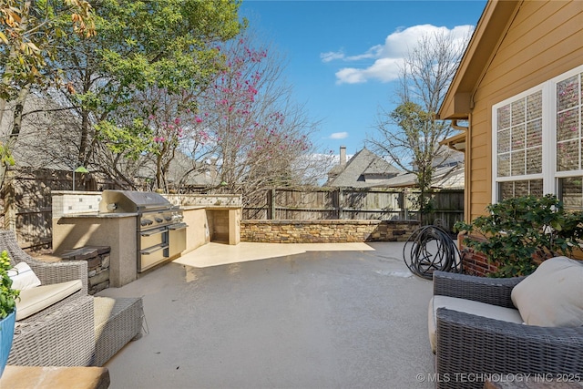 view of patio / terrace featuring area for grilling and a fenced backyard