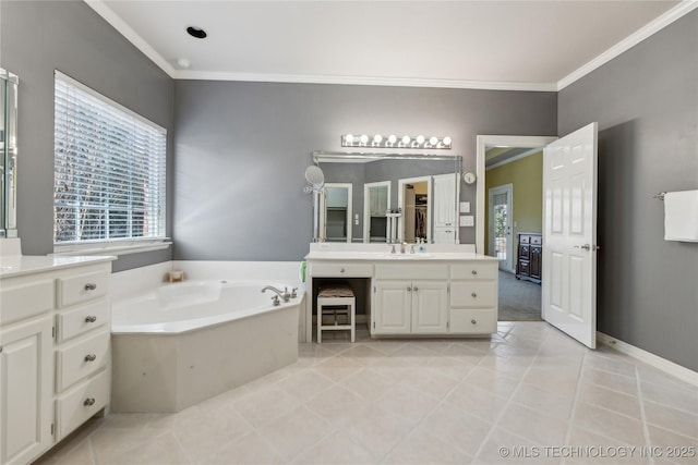 bathroom with tile patterned flooring, a bath, vanity, and ornamental molding