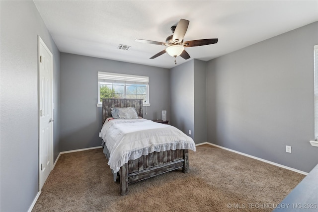 carpeted bedroom featuring visible vents, baseboards, and ceiling fan