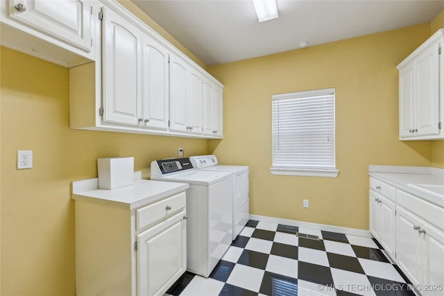 clothes washing area featuring baseboards, dark floors, washer and dryer, cabinet space, and a sink