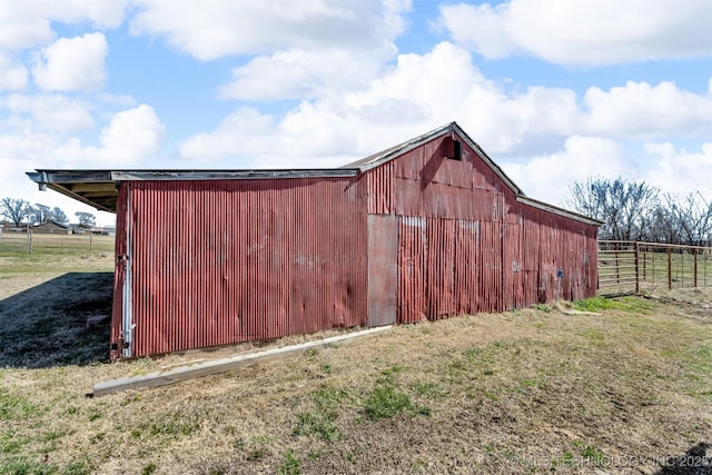 view of outbuilding with an outbuilding and fence