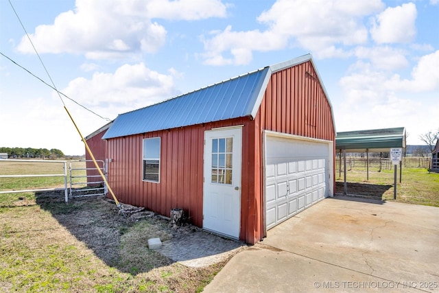 detached garage featuring a gate and fence