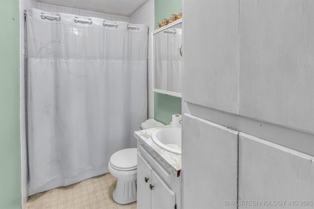 full bathroom featuring tile patterned floors, toilet, and vanity