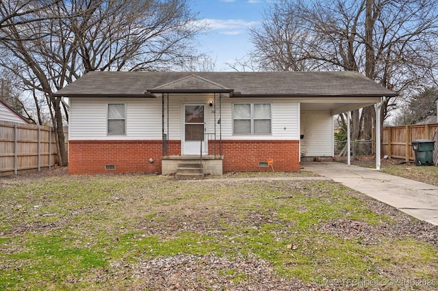 bungalow featuring fence, brick siding, driveway, and crawl space