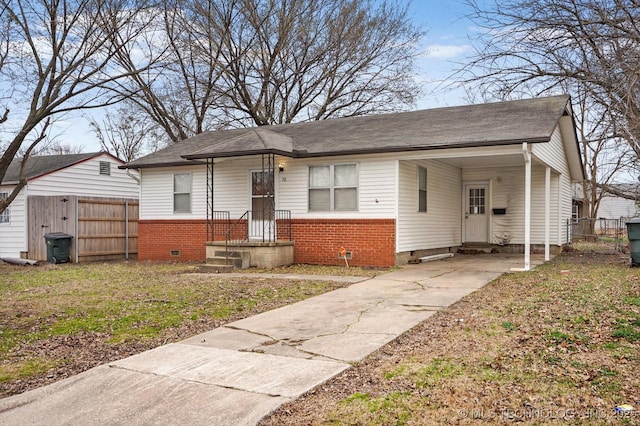 bungalow featuring fence, brick siding, and crawl space