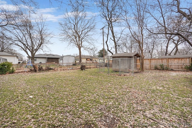 view of yard featuring an outbuilding and a fenced backyard