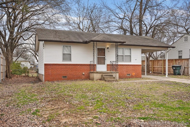 bungalow-style house featuring crawl space, brick siding, concrete driveway, and fence