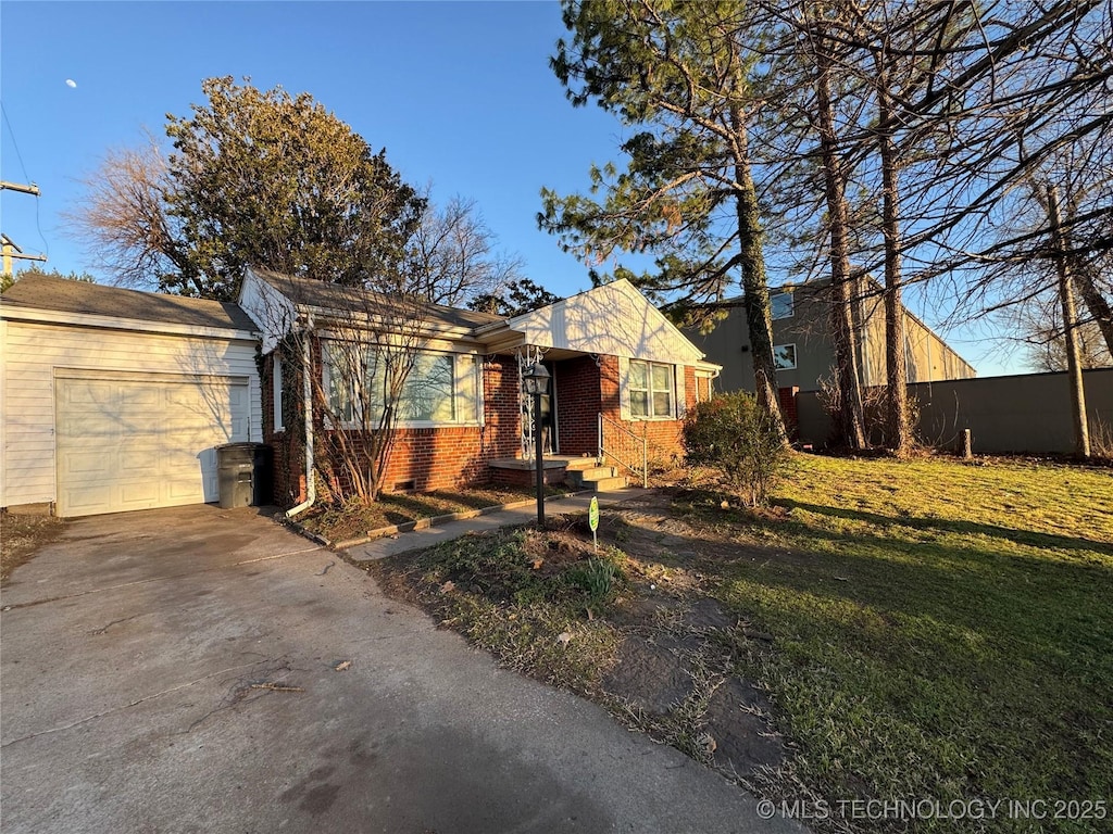 single story home featuring brick siding, driveway, and a front lawn