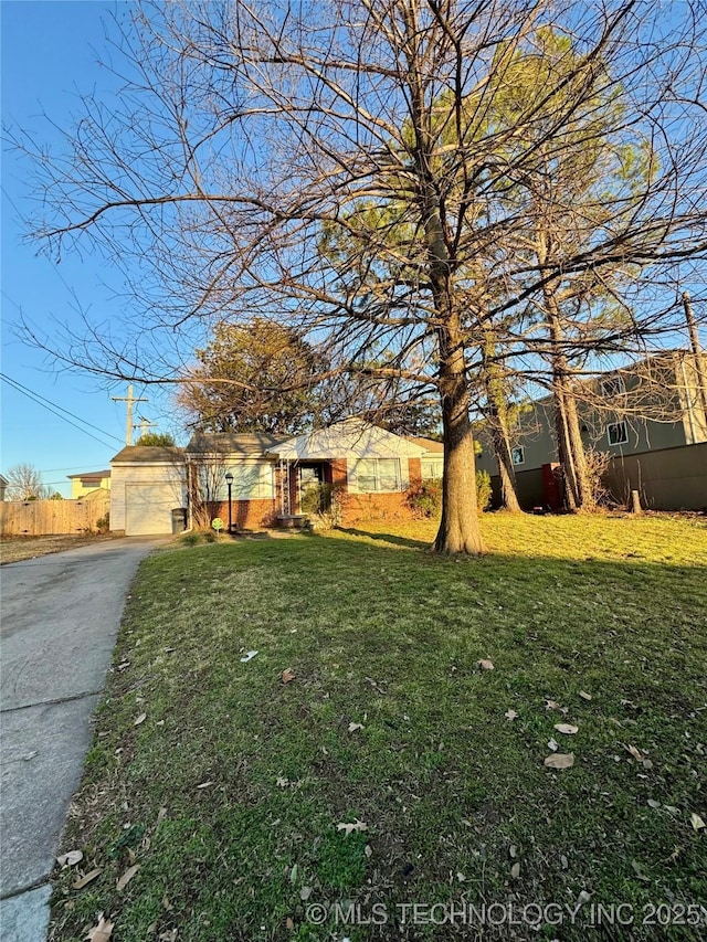 view of front of property with a garage, driveway, and a front yard