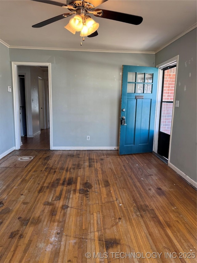 foyer entrance featuring hardwood / wood-style floors, crown molding, baseboards, and ceiling fan