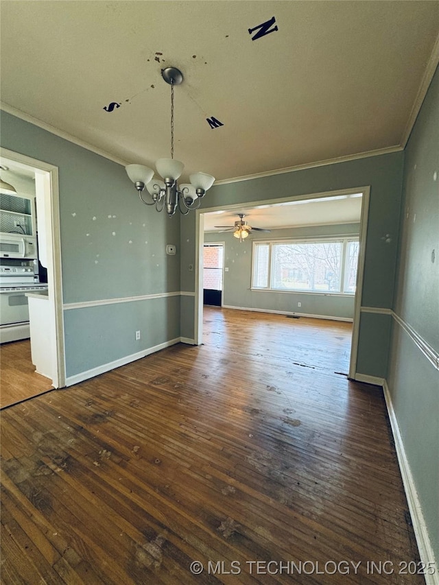 unfurnished room featuring wood-type flooring, ornamental molding, ceiling fan with notable chandelier, and baseboards