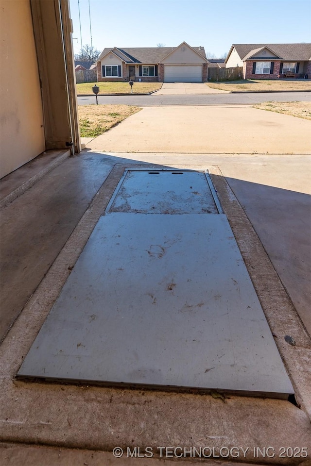 exterior space featuring a residential view and driveway